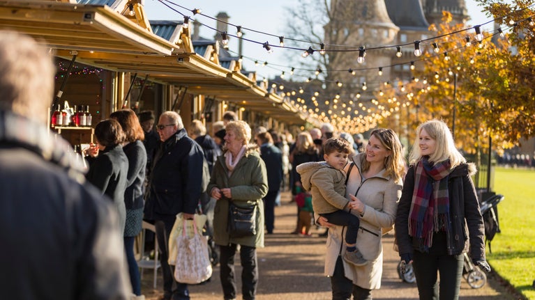 Visitors exploring the Christmas market at Waddesdon Manor, Buckinghamshire